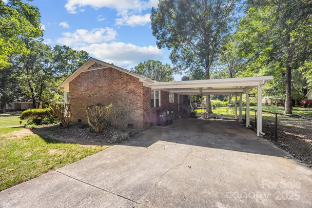 a view of a patio with a table and chairs under an umbrella