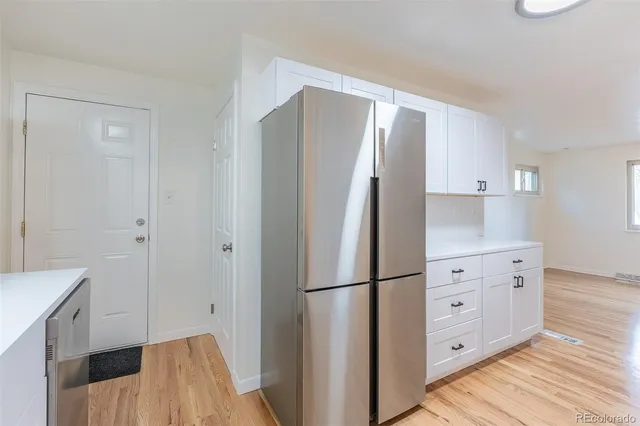 a kitchen with cabinets and stainless steel appliances