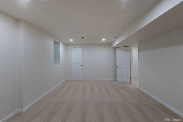 a view of an empty room with a window