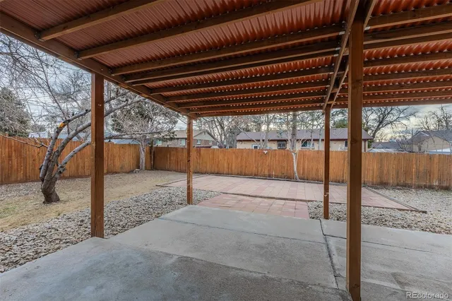 a view of a yard with a house and a tree