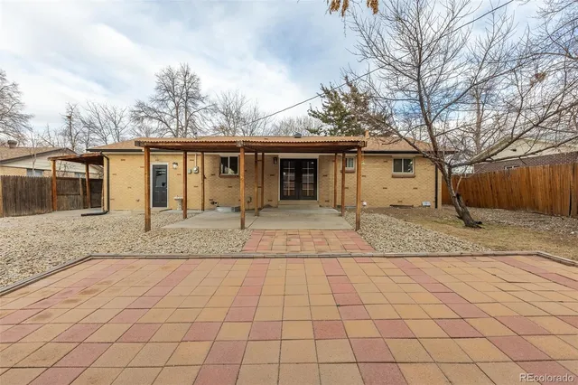 a view of a house with a sink and wooden fence