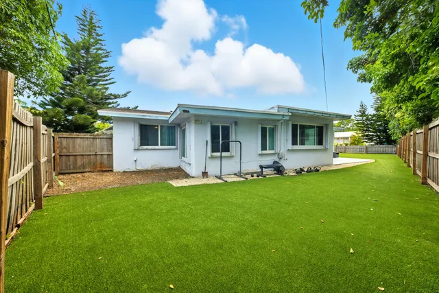 a view of a house with backyard and garden
