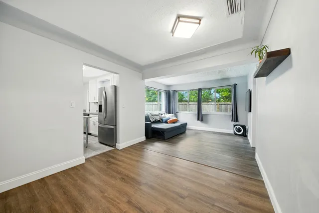 a view of a livingroom with furniture and a ceiling fan