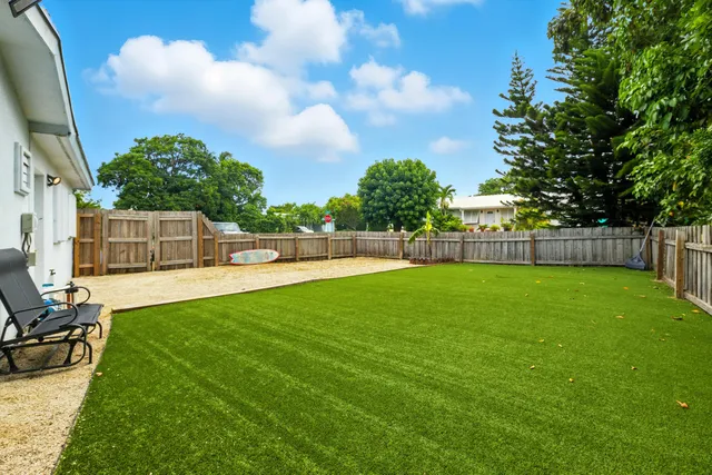 a view of a backyard with a garden and entertaining space