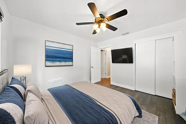 a bedroom with a bed and a flat screen tv