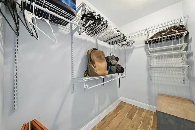 a bathroom with a granite countertop sink a toilet and shower