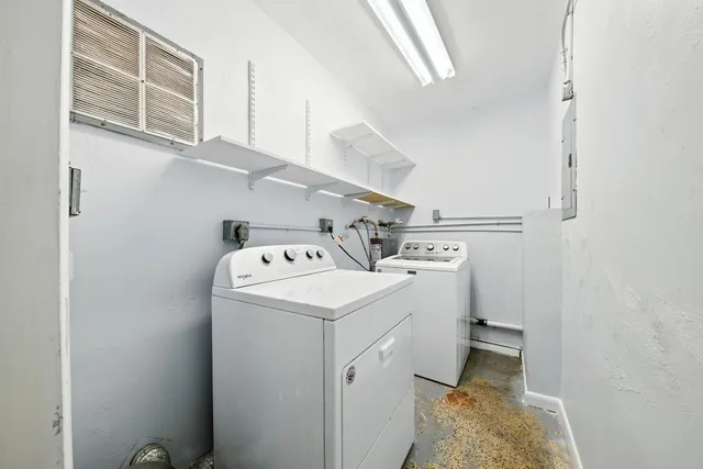 a view of storage and utility room with washer and dryer