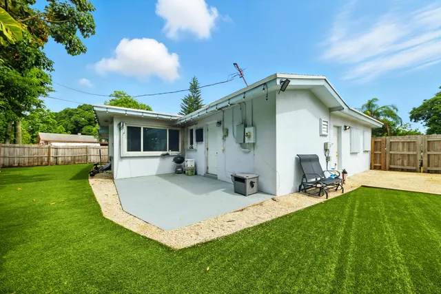 a front view of house with a garden and patio