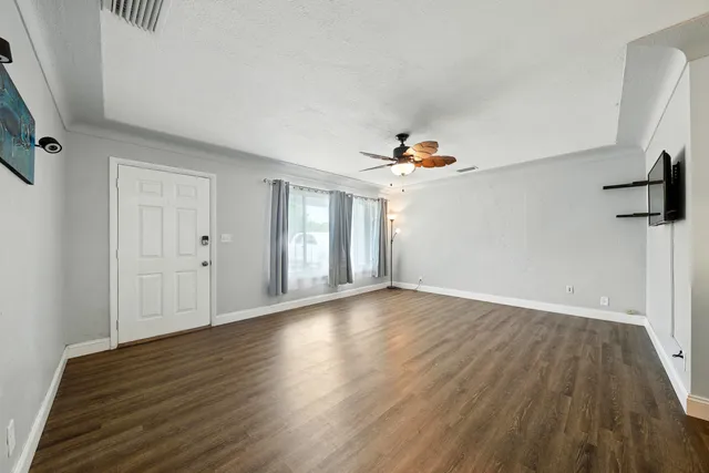 a view of a livingroom with wooden floor and window