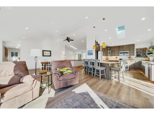 a living room with furniture and kitchen view