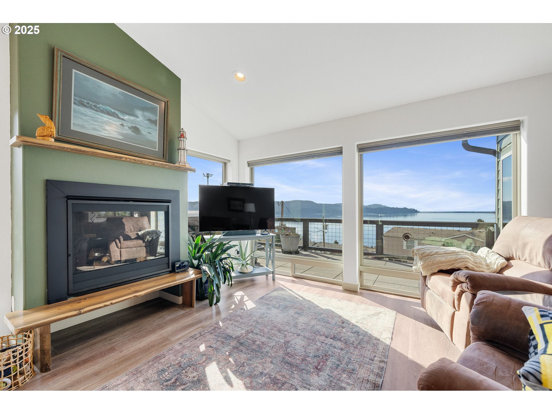 9065 8th Street Bay City, OR 97107 - Photo 14 of 48 a living room with furniture a flat screen tv and a fireplace