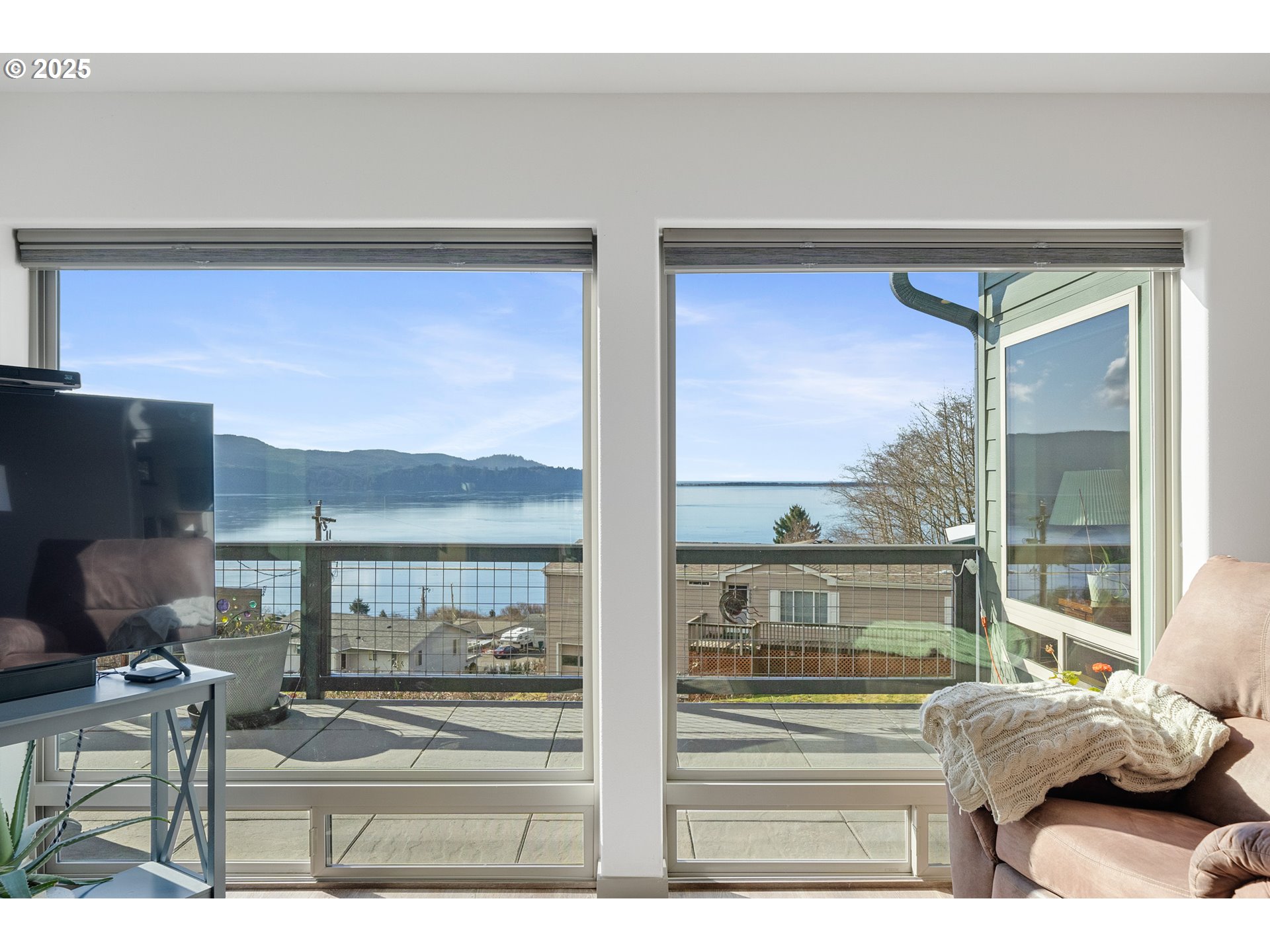 9065 8th Street Bay City, OR 97107 - Photo 16 of 48 a living room with couches chairs and a floor to ceiling window