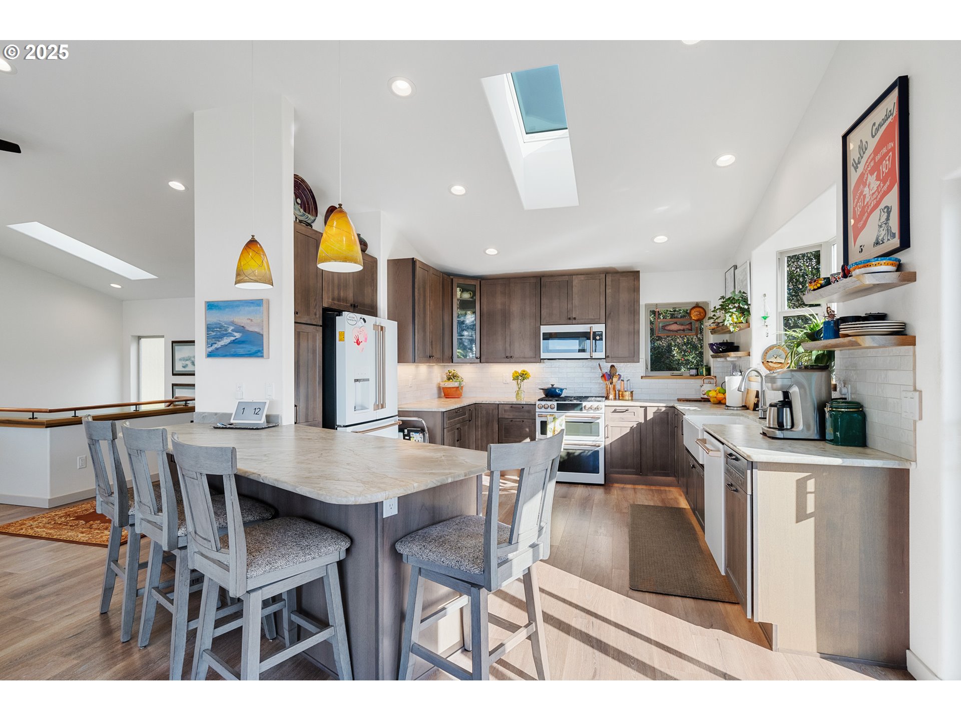 9065 8th Street Bay City, OR 97107 - Photo 18 of 48 a kitchen with stainless steel appliances kitchen island granite countertop a dining table chairs and a refrigerator