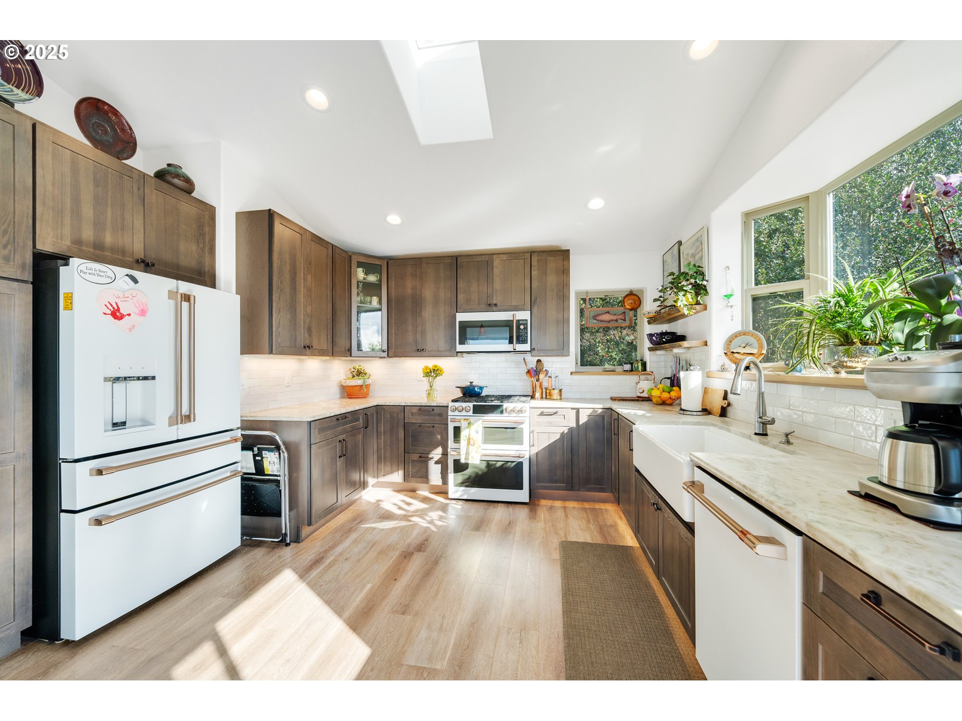 9065 8th Street Bay City, OR 97107 - Photo 19 of 48 a open kitchen with cabinets a sink and white appliances