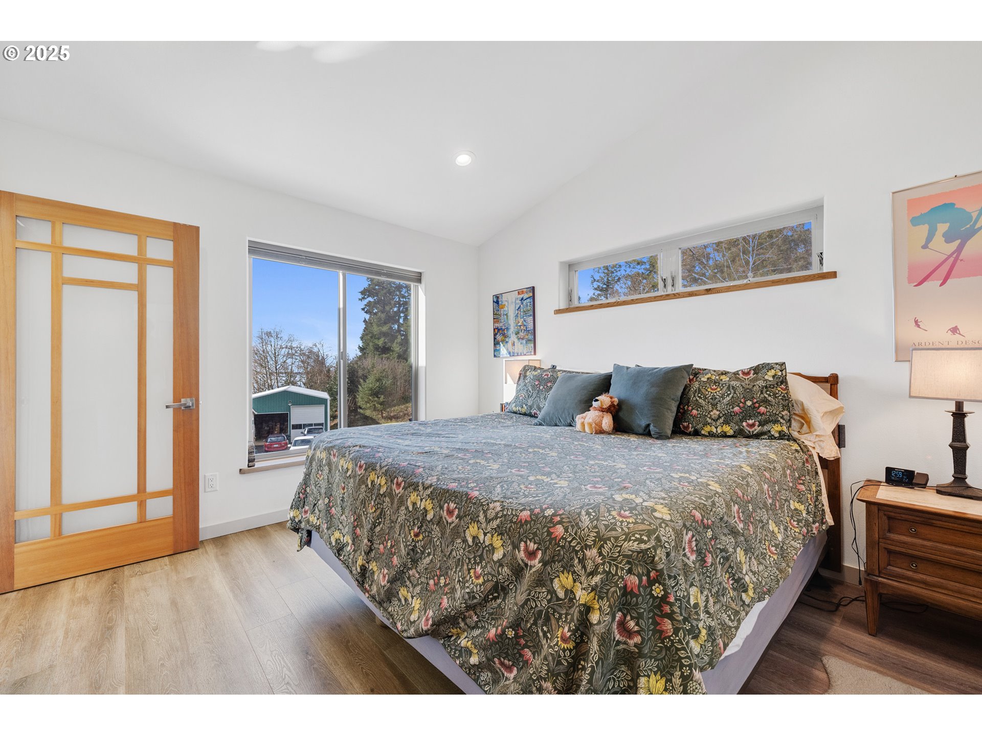 9065 8th Street Bay City, OR 97107 - Photo 21 of 48 a bedroom with a large bed and a wooden floor
