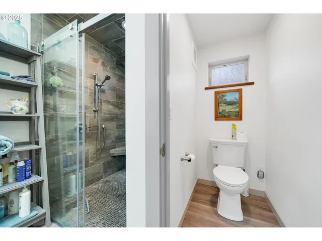 a bathroom with a toilet and a shower