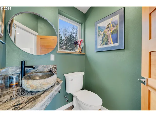 a bathroom with a toilet a sink and mirror