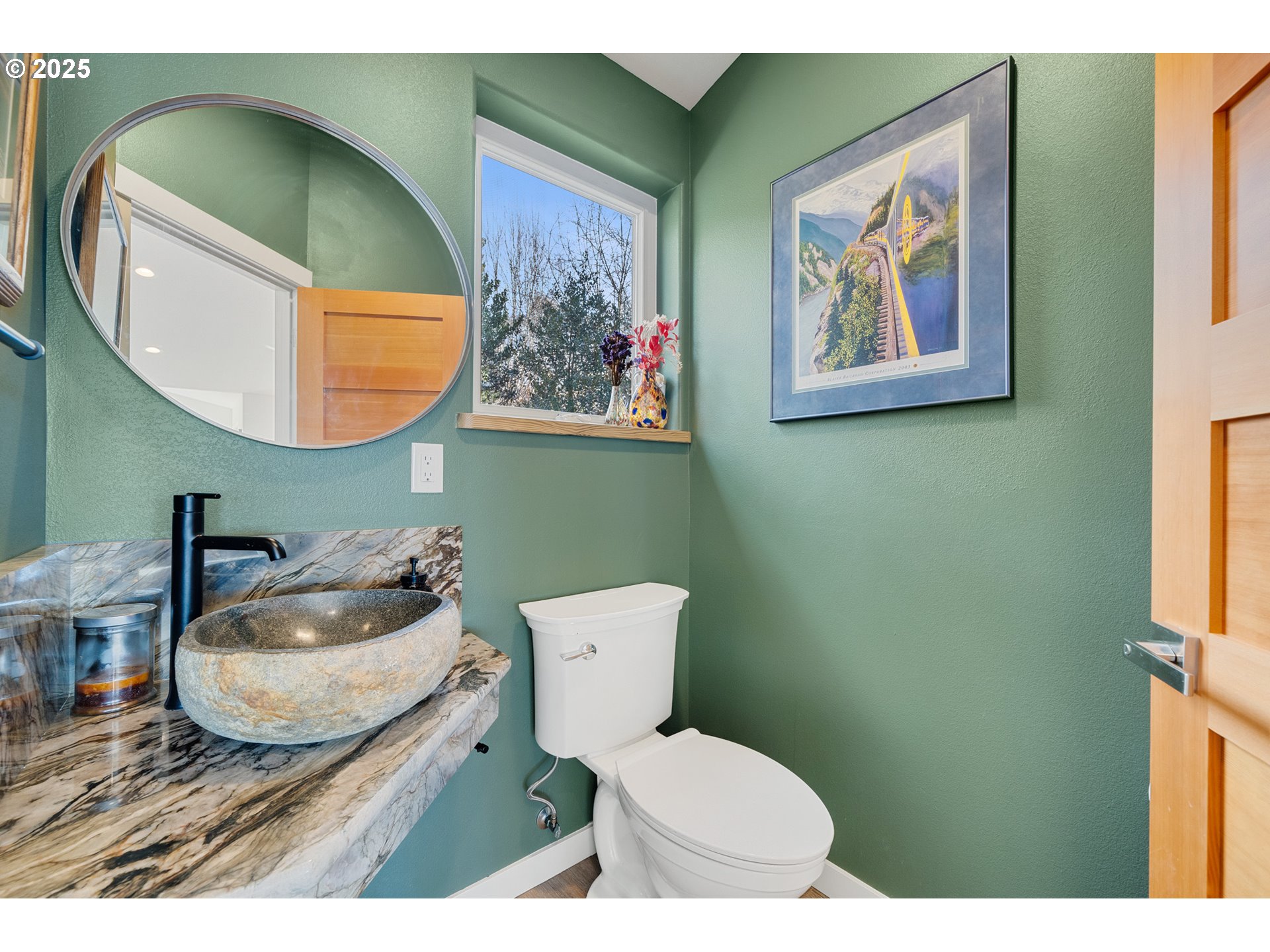 9065 8th Street Bay City, OR 97107 - Photo 28 of 48 a bathroom with a toilet a sink and mirror