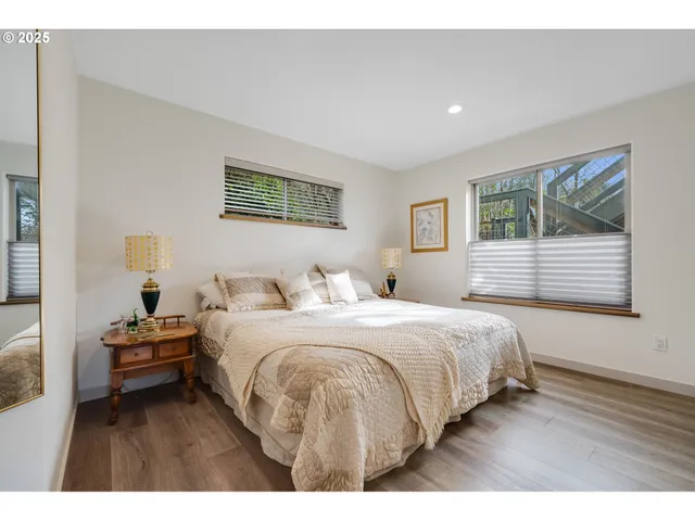 a bedroom with a bed and a night stand