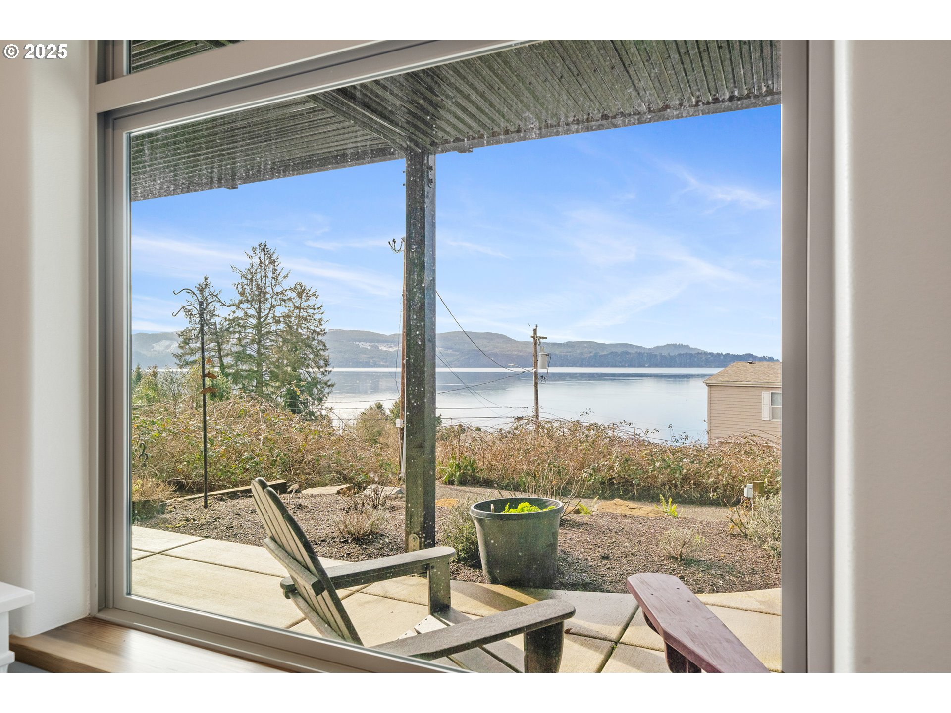 9065 8th Street Bay City, OR 97107 - Photo 37 of 48 a view of a balcony with floor to ceiling windows with wooden floor