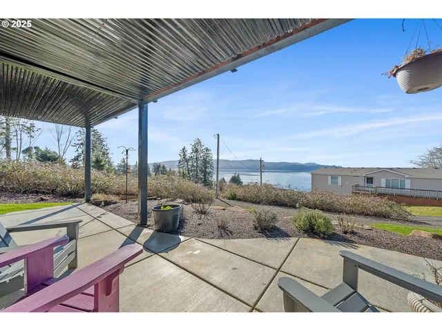 a view of a terrace with furniture and a garden