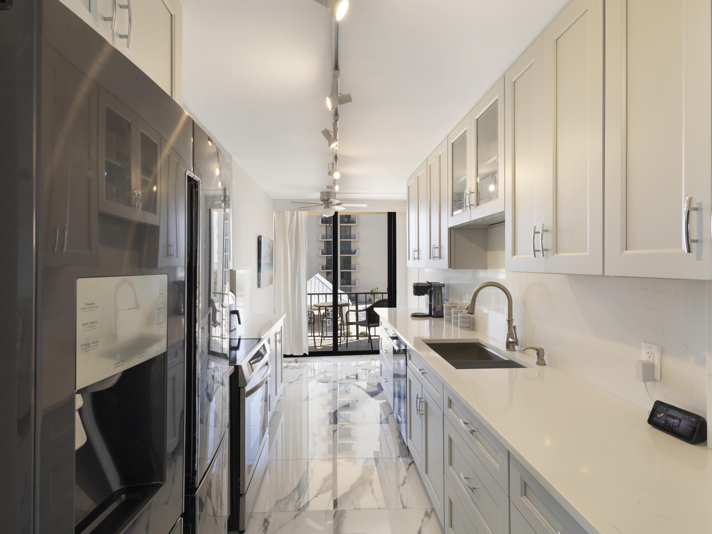 4200 North Ocean Drive, Unit 2301 Singer Island, FL 33404 - Photo 12 of 52 a kitchen with stainless steel appliances a sink a stove and a refrigerator
