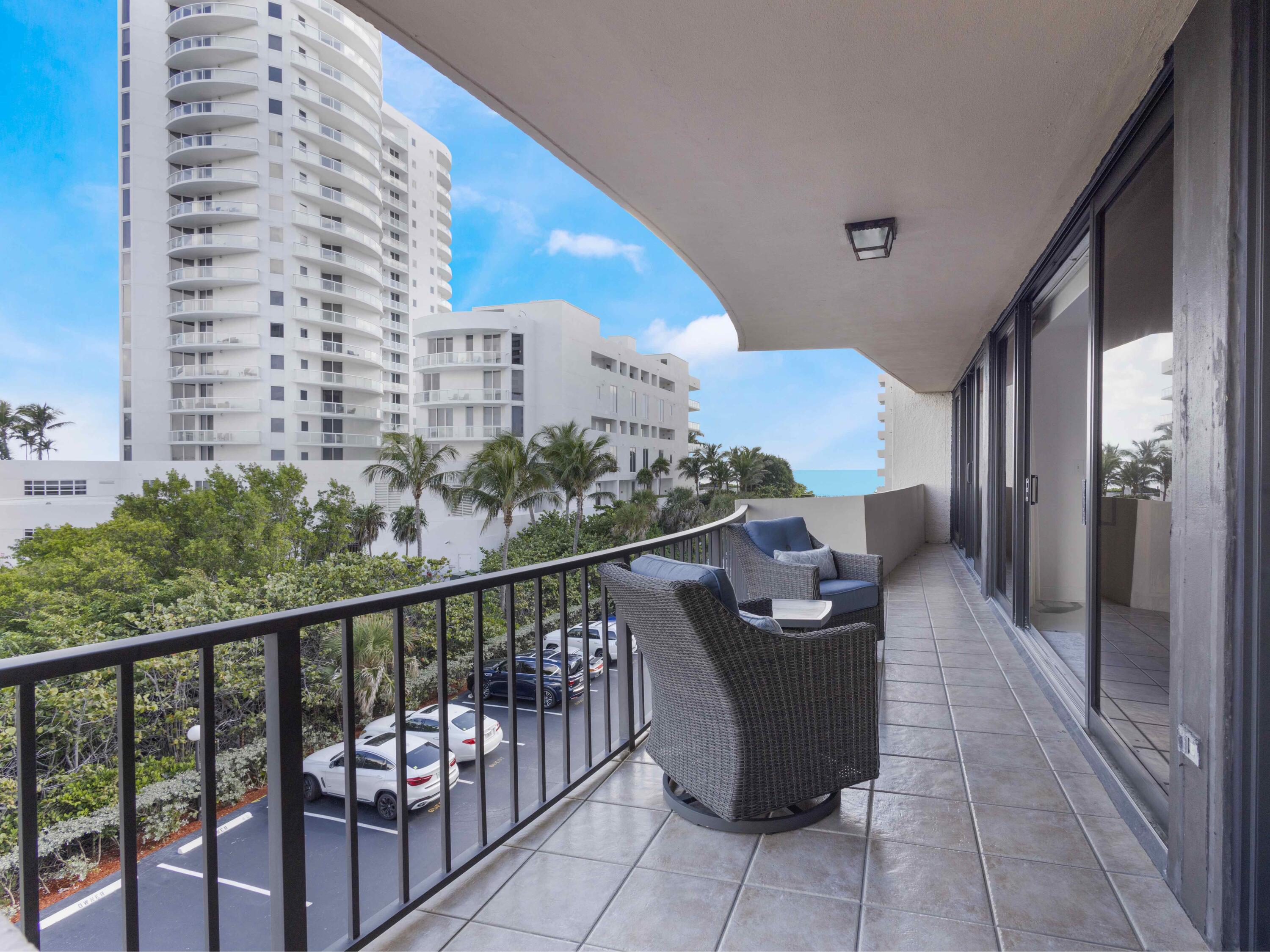 4200 North Ocean Drive, Unit 2301 Singer Island, FL 33404 - Photo 13 of 52 a view of a balcony with chairs and wooden fence