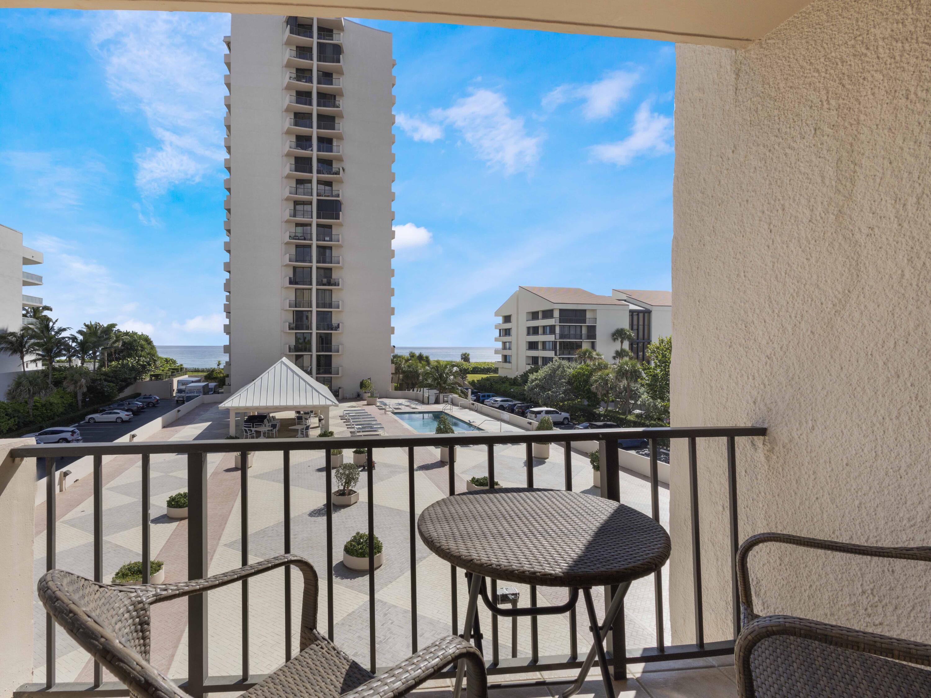 4200 North Ocean Drive, Unit 2301 Singer Island, FL 33404 - Photo 14 of 52 a view of a balcony with a table and chairs