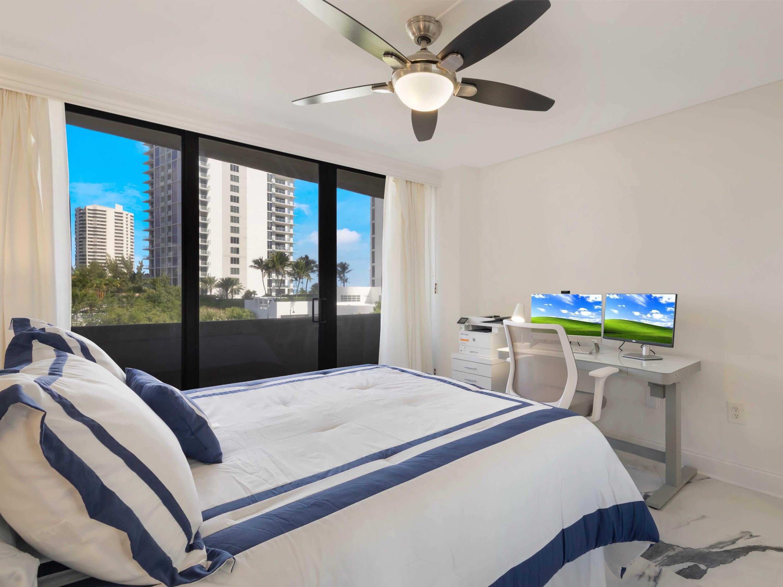 4200 North Ocean Drive, Unit 2301 Singer Island, FL 33404 - Photo 19 of 52 a bedroom with a bed and a chandelier