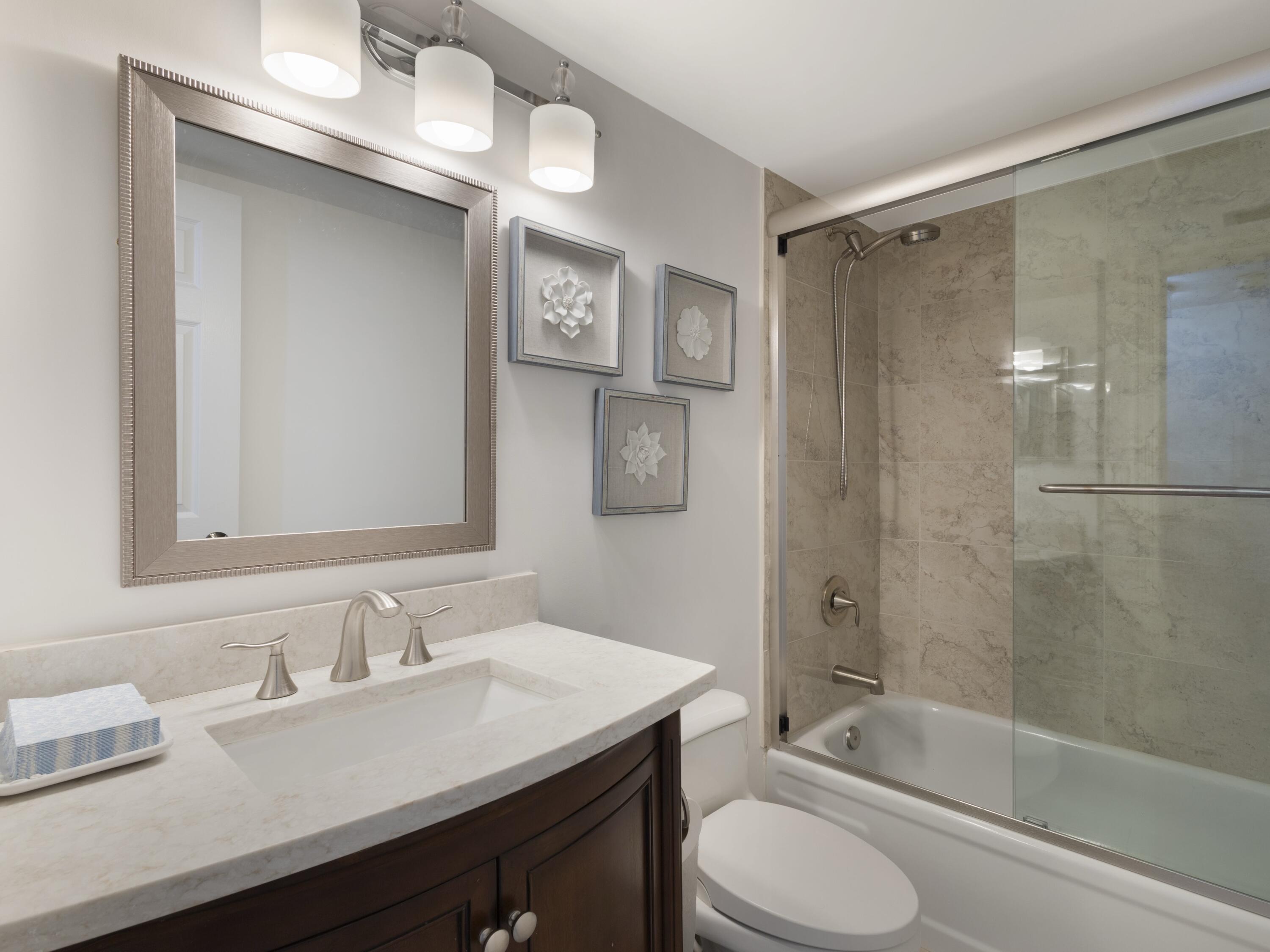 4200 North Ocean Drive, Unit 2301 Singer Island, FL 33404 - Photo 20 of 52 a bathroom with a granite countertop sink toilet and shower