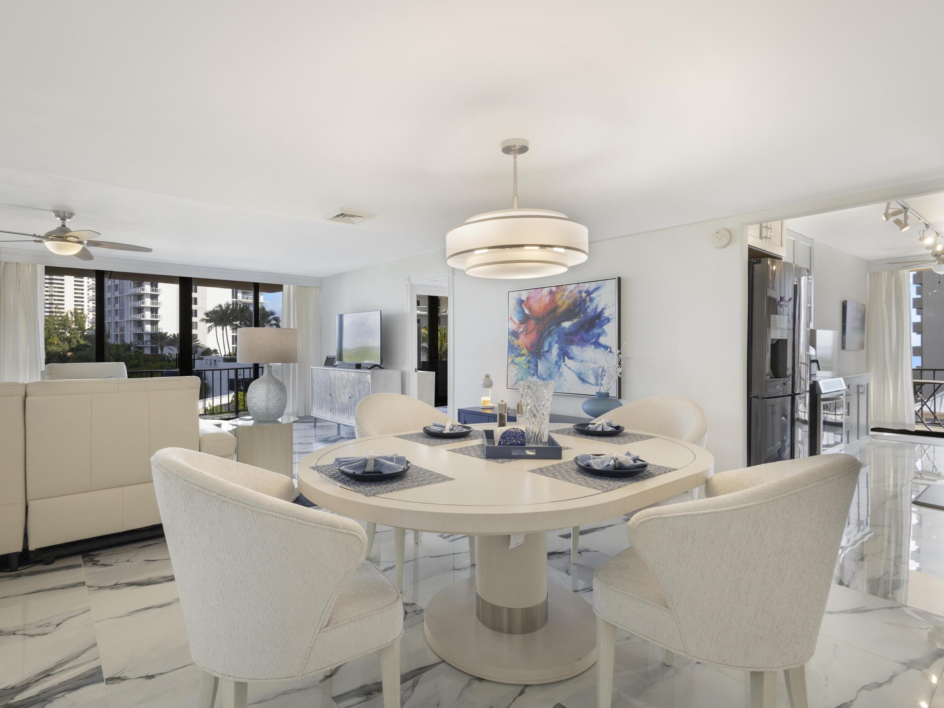 4200 North Ocean Drive, Unit 2301 Singer Island, FL 33404 - Photo 2 of 52 a view of a dining room with furniture wooden floor and chandelier
