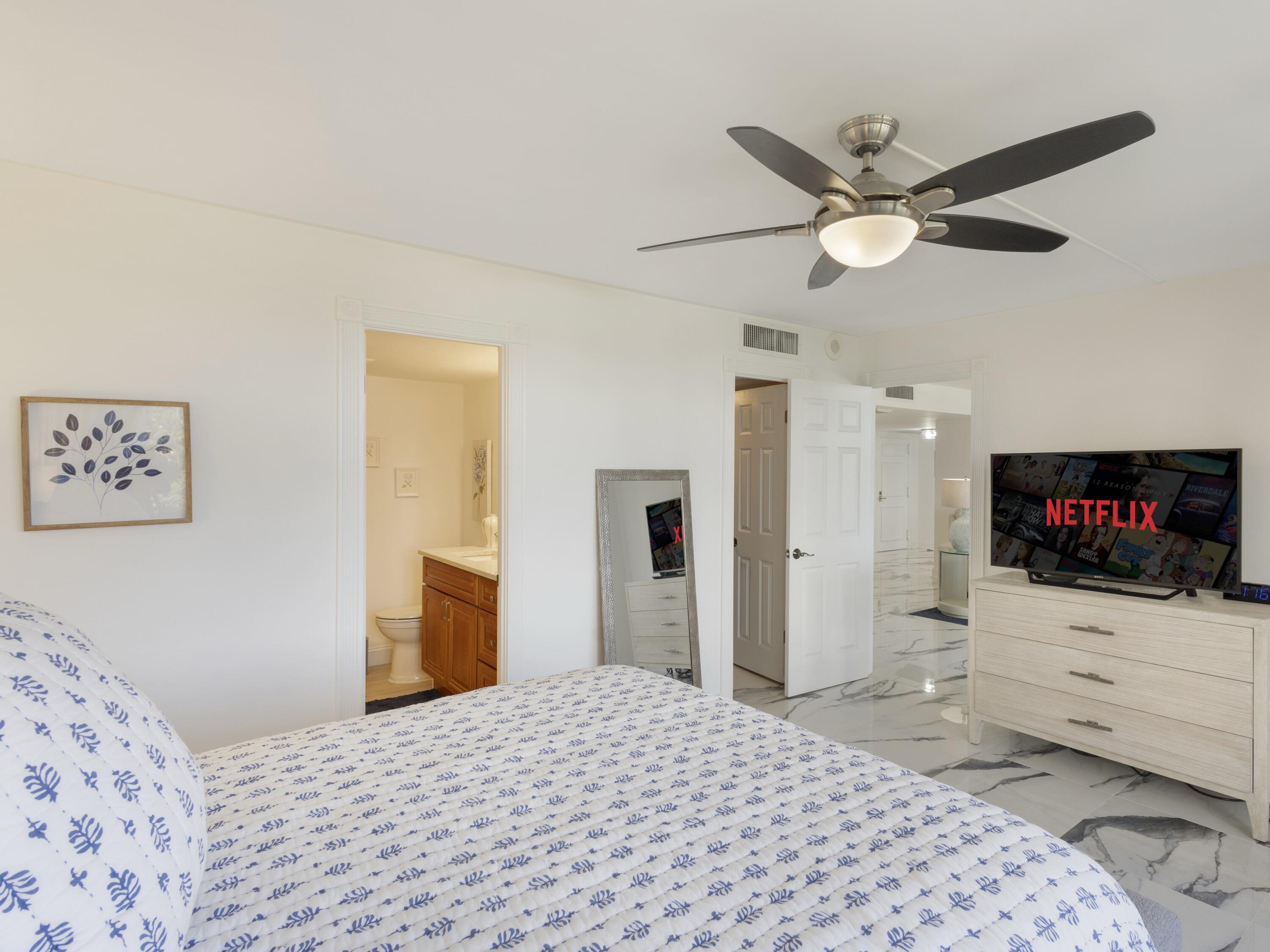 4200 North Ocean Drive, Unit 2301 Singer Island, FL 33404 - Photo 22 of 52 a bedroom with a bed and a flat screen tv