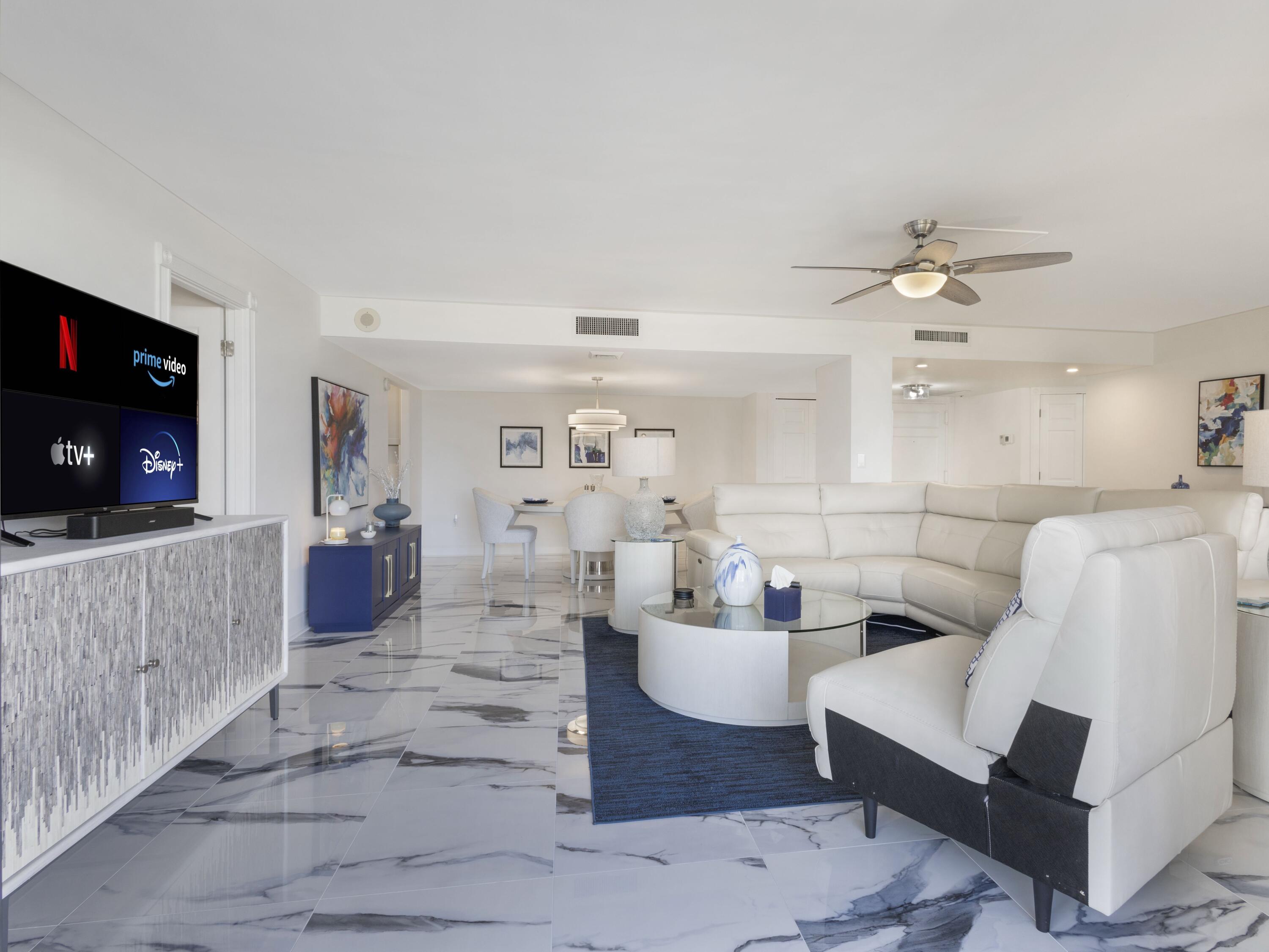 4200 North Ocean Drive, Unit 2301 Singer Island, FL 33404 - Photo 5 of 52 a living room with furniture a flat screen tv and a fireplace