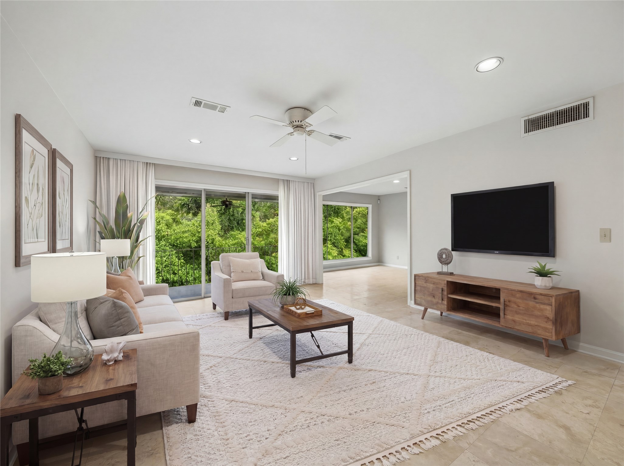 6659 Bayou Glen Road Houston, TX 77057 - Photo 23 of 23 VIRTUALLY STAGED. Spacious living area with incredible views off the balcony. The floors are travertine natural stone flooring complimented by the soft neutral painted walls. Great open floorplan!