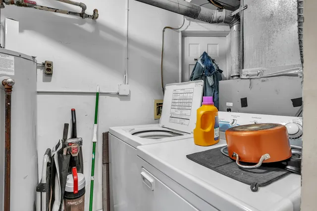 a kitchen with a sink and a stove with wooden floor