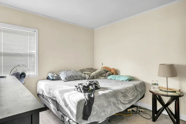 a bedroom with a bed and a table