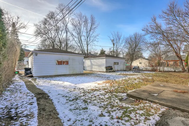 a view of a yard covered in snow