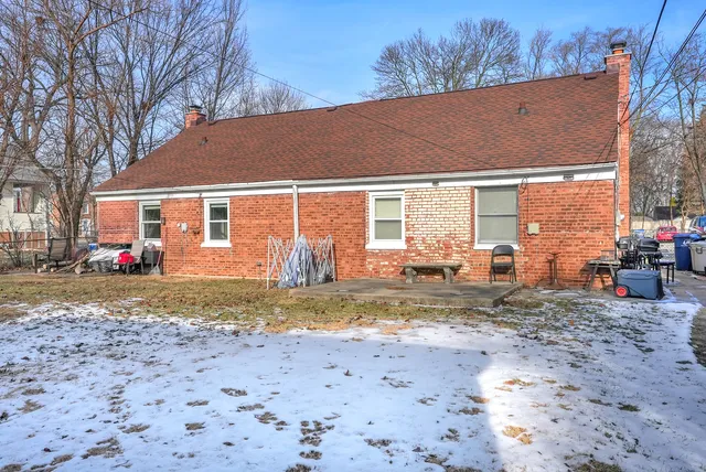 a view of a house with backyard and sitting area