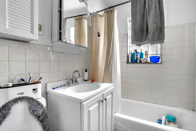 a bathroom with a sink vanity tub and a mirror
