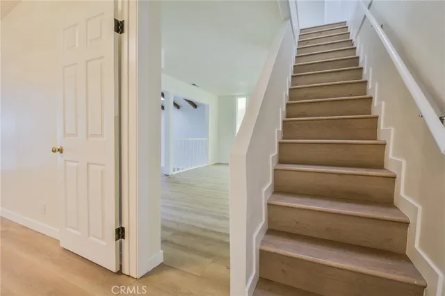 a view of entryway with wooden floor and stairs