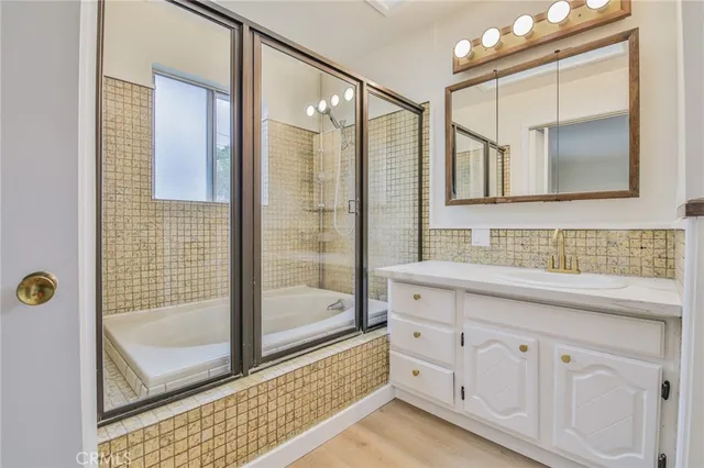 a bathroom with a sink a mirror and a shower