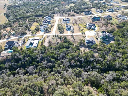 an aerial view of residential building with green space