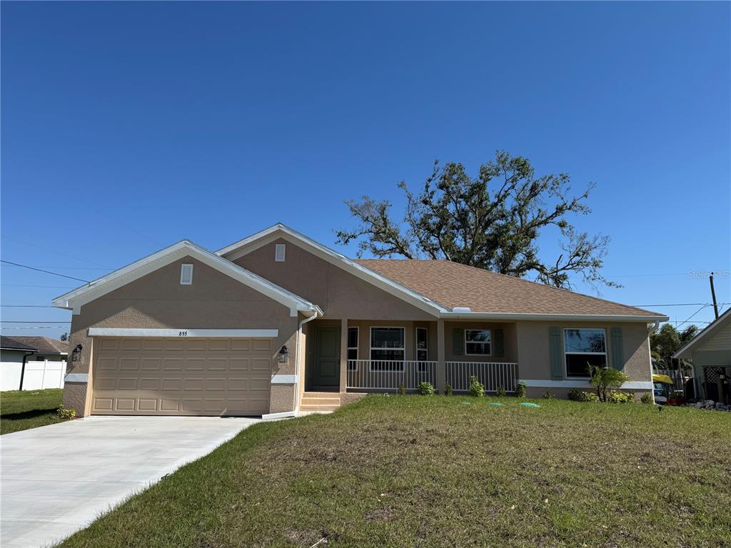 855 Cumberland Road Venice, FL 34293 - Photo 1 of 1 a front view of a house with a garden