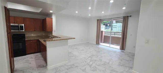 a view of kitchen cabinets and stainless steel appliances