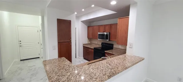 a kitchen with a refrigerator and a stove