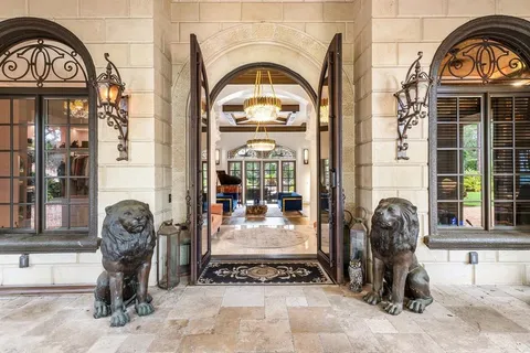 a bedroom with a large bed and a chandelier