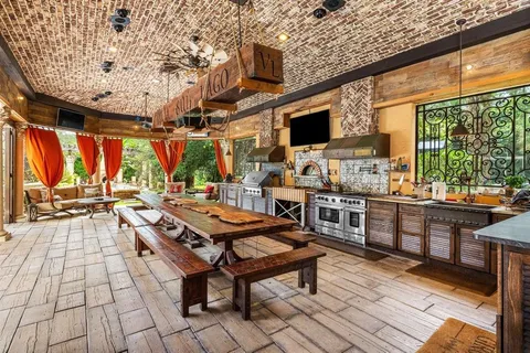 a living room with patio furniture and a floor to ceiling window