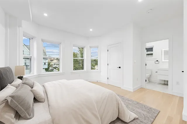 a spacious bedroom with a bed and a couch