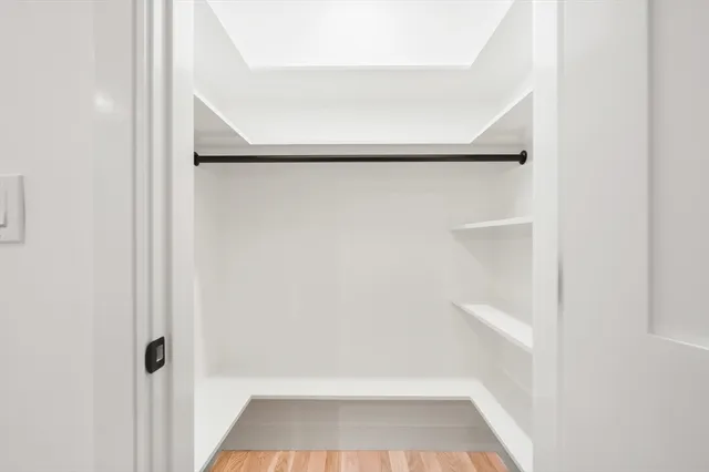 a view of walk in closet with empty racks