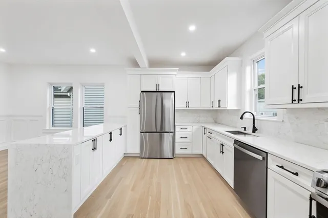 a kitchen with granite countertop cabinets stainless steel appliances a sink and a counter top space
